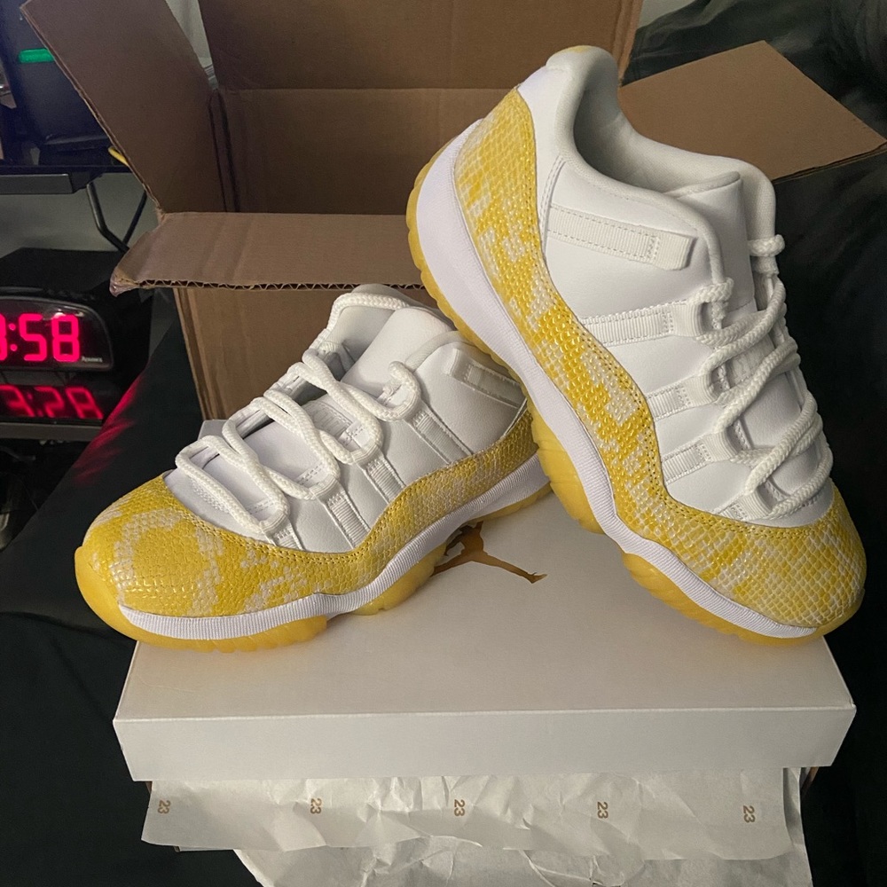 BRAND NEW, Never worn, Air Jordan 11 Retro Low White/Tour Yellow. Size 8 Women.